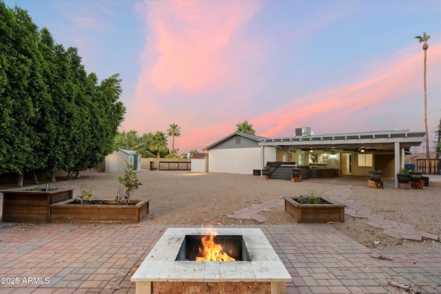 2726 W Meseto Cir, Mesa, AZ 85202 - fenced backyard featuring a patio area, a fire pit, a garden, a shed, and an in-ground hot tub