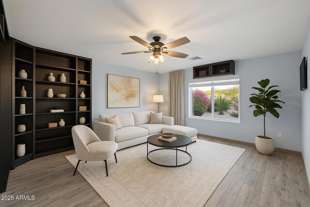 2726 W Meseto Cir, Mesa, AZ 85202 - living area with a ceiling fan and light wood-style flooring