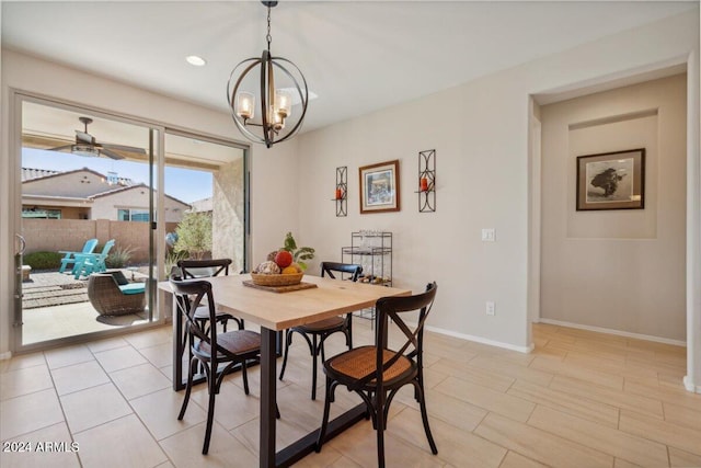 dining room with ceiling fan with notable chandelier