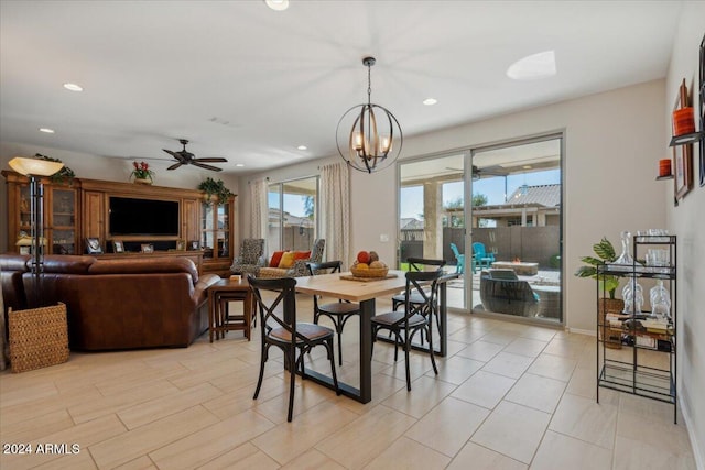 dining area with ceiling fan with notable chandelier