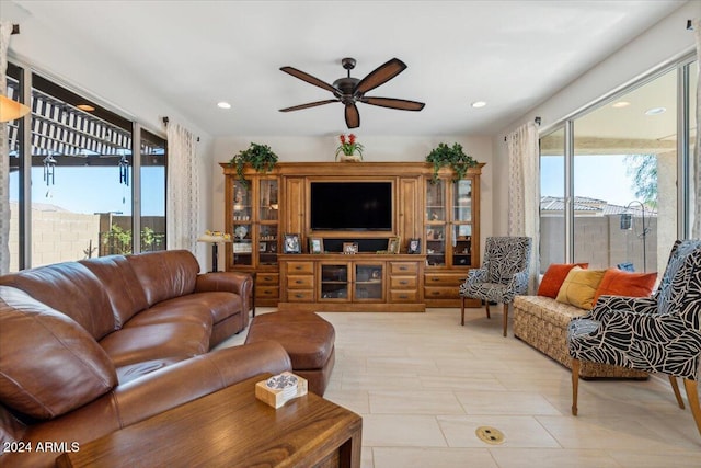 living room with a healthy amount of sunlight, ceiling fan, and light tile patterned floors