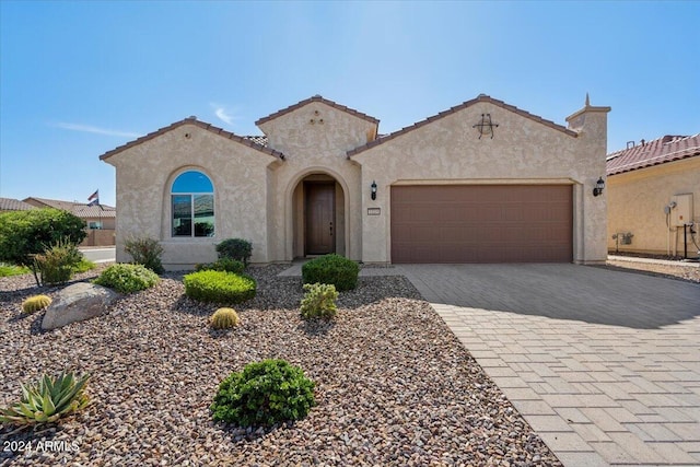 mediterranean / spanish-style house featuring a garage