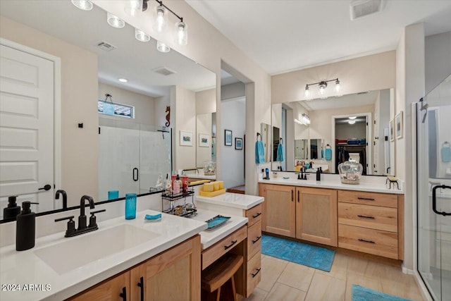 bathroom featuring vanity and an enclosed shower