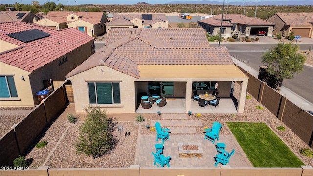 back of house with a patio and an outdoor fire pit