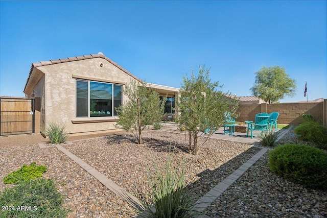 rear view of house featuring a patio