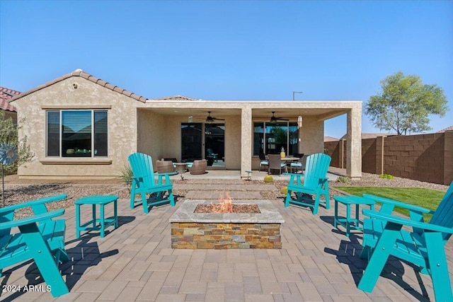 back of property featuring a patio, a fire pit, and ceiling fan