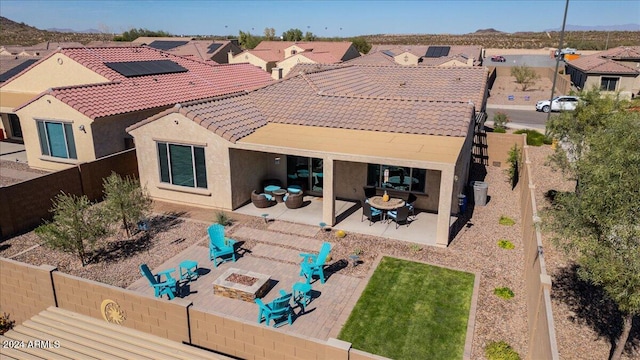 back of house featuring a patio and an outdoor fire pit