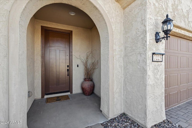 doorway to property featuring a garage and elevator