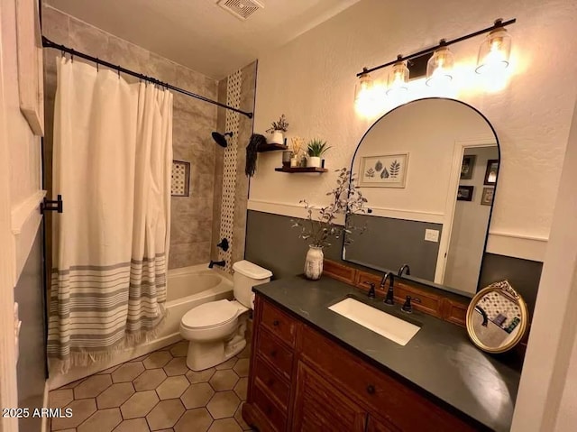 full bathroom featuring vanity, shower / bath combination with curtain, tile patterned floors, and toilet