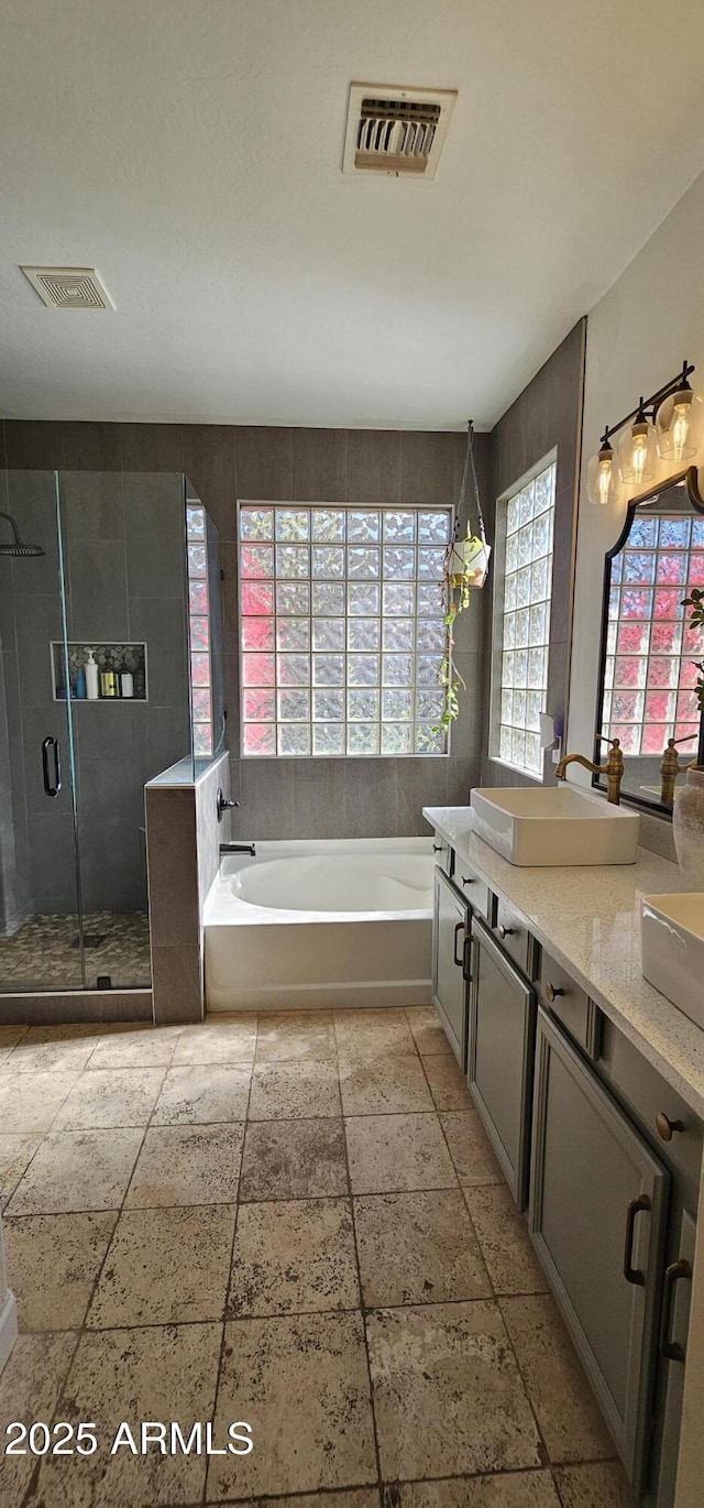 bathroom featuring vanity and plus walk in shower