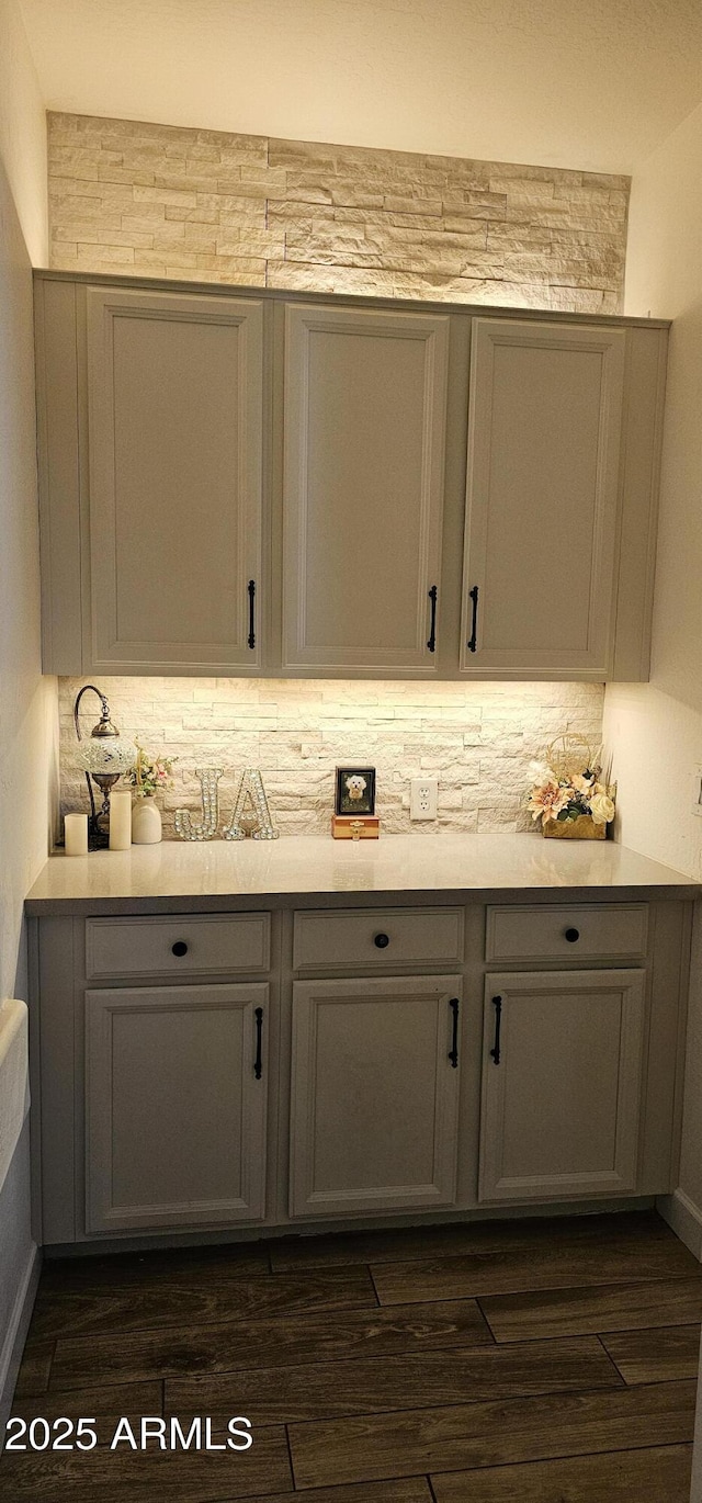 bathroom featuring hardwood / wood-style flooring and tasteful backsplash