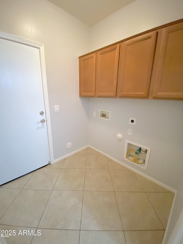 laundry room with gas dryer hookup, hookup for a washing machine, electric dryer hookup, light tile patterned floors, and cabinets