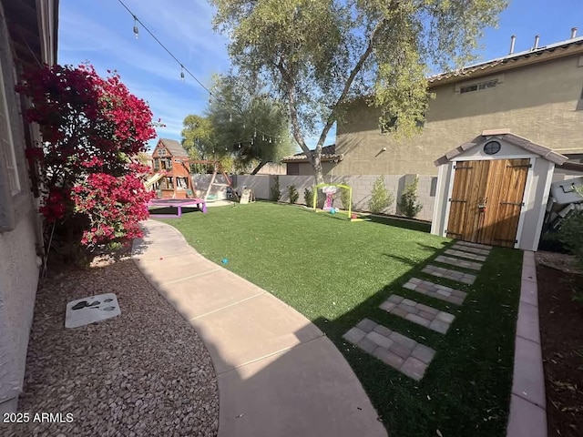 view of yard featuring a shed and a playground