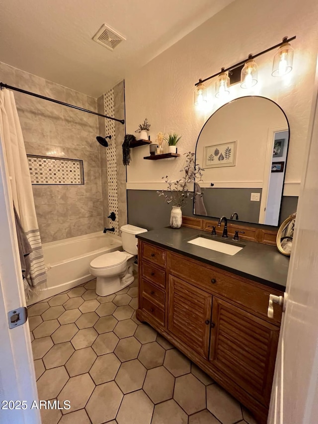 full bathroom with shower / tub combo, vanity, tile patterned flooring, and toilet