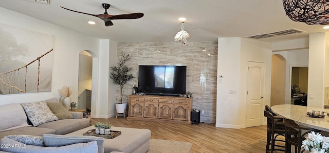 living room with light hardwood / wood-style floors and ceiling fan