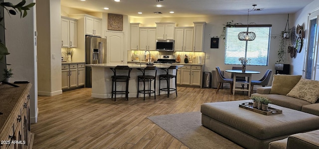 living room with sink and light hardwood / wood-style flooring