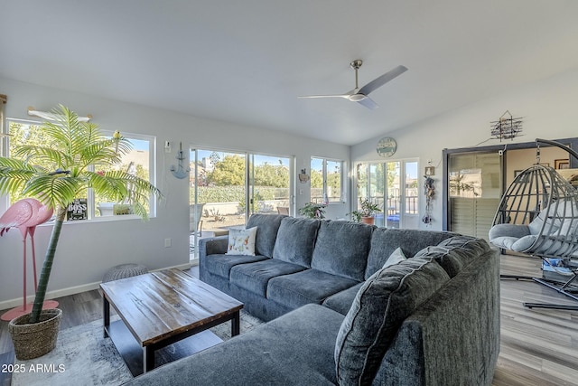 living room with light wood-type flooring, ceiling fan, and lofted ceiling