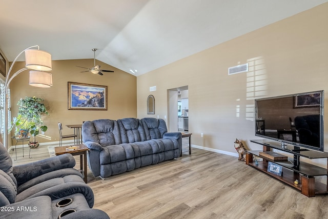 living room featuring light wood-type flooring, vaulted ceiling, and ceiling fan