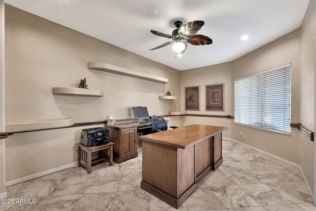 office area featuring marble finish floor, ceiling fan, and baseboards