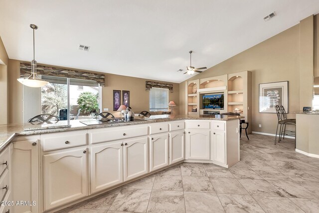 kitchen featuring lofted ceiling, ceiling fan, a peninsula, black stovetop, and pendant lighting