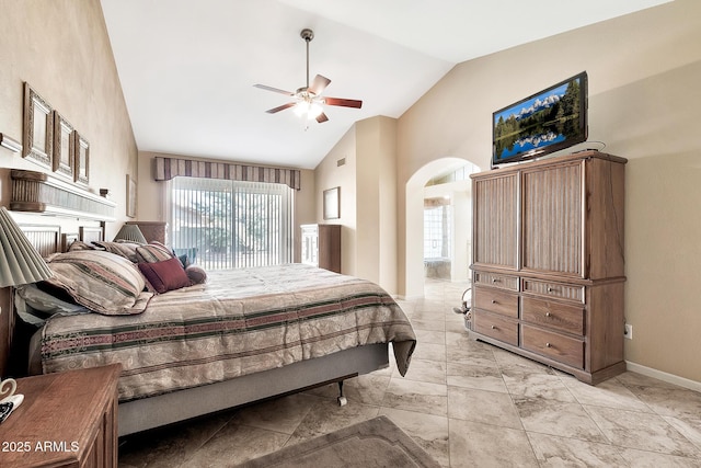 bedroom featuring arched walkways, high vaulted ceiling, a ceiling fan, and baseboards