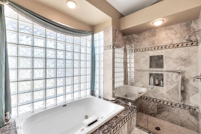 bathroom featuring a whirlpool tub and a shower stall