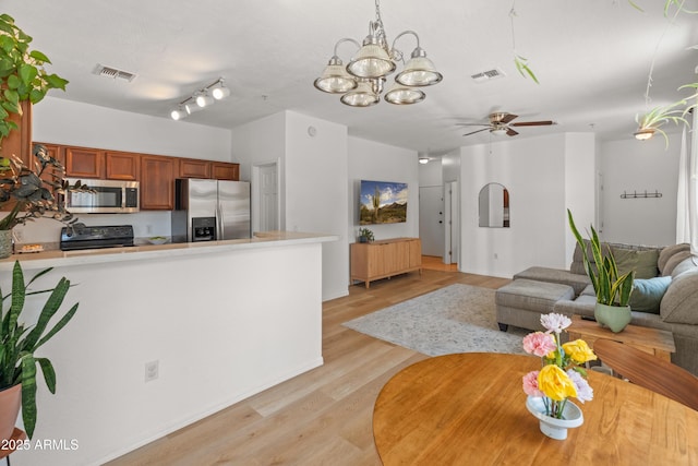 2150 E Bell Rd Unit 1088, Phoenix, AZ 85022 - kitchen with appliances with stainless steel finishes, light wood-style flooring, light countertops, ceiling fan, and brown cabinetry