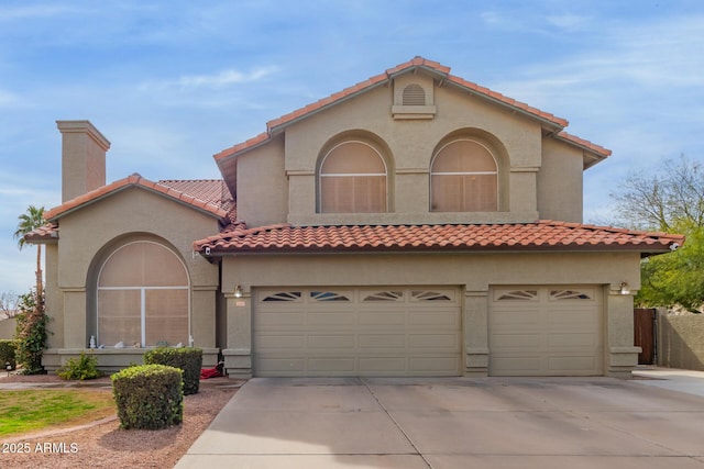 mediterranean / spanish home featuring a garage, concrete driveway, a chimney, and stucco siding