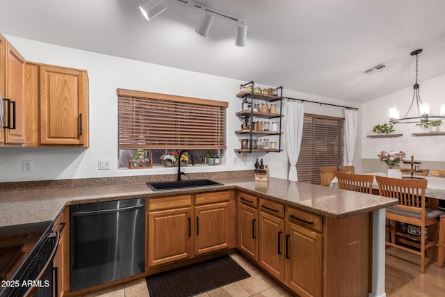 kitchen with a peninsula, dishwashing machine, brown cabinets, and a sink