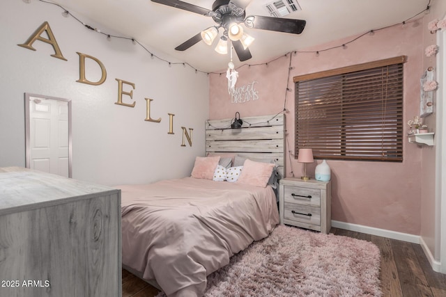 bedroom with a ceiling fan, baseboards, visible vents, and wood finished floors