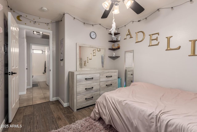 bedroom with dark wood-style flooring and baseboards