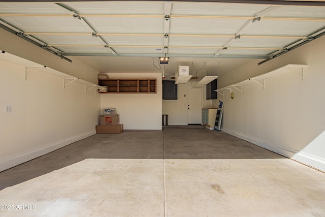 garage featuring baseboards and a garage door opener