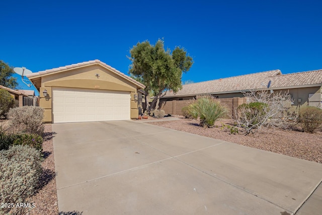 view of front of house featuring a garage, a tile roof, driveway, and stucco siding