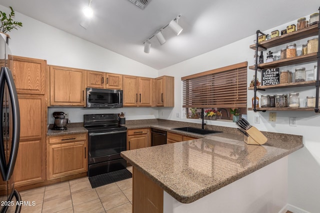 kitchen with lofted ceiling, open shelves, a sink, black appliances, and dark stone countertops