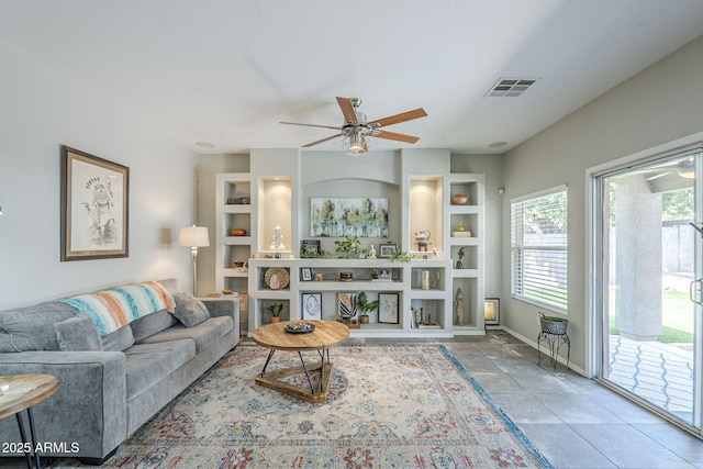 15848 W Calavar Rd, Surprise, AZ 85379 - living room with a ceiling fan, built in shelves, and baseboards