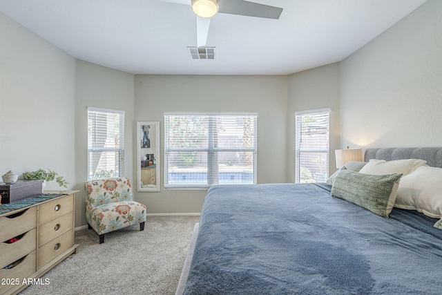 15848 W Calavar Rd, Surprise, AZ 85379 - bedroom with multiple windows, light carpet, baseboards, and a ceiling fan