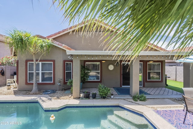 15848 W Calavar Rd, Surprise, AZ 85379 - back of house featuring stucco siding, a patio, an outdoor pool, and fence