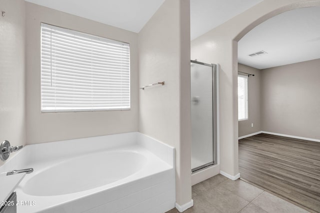 bathroom featuring shower with separate bathtub and tile patterned floors