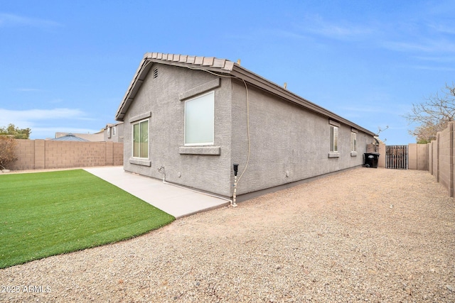 rear view of house with a patio area and a lawn