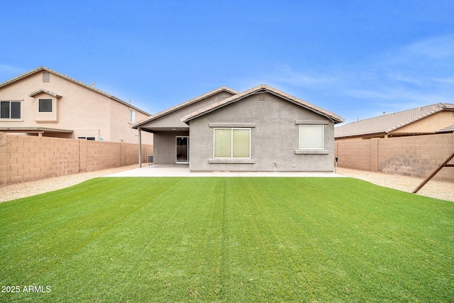 back of property featuring a yard and a patio area