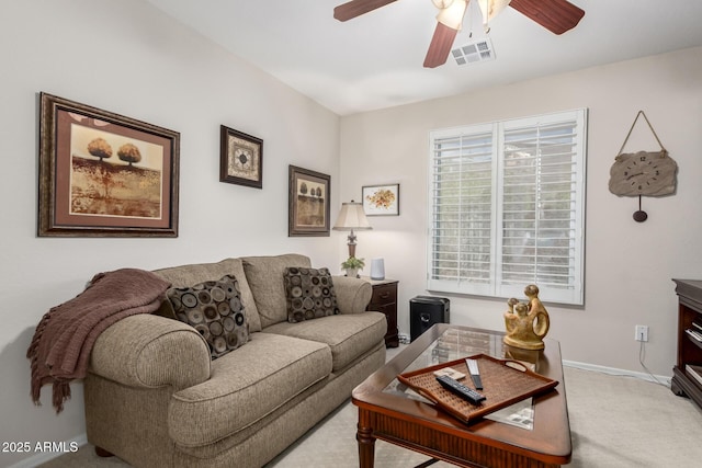 carpeted living room featuring visible vents, ceiling fan, and baseboards