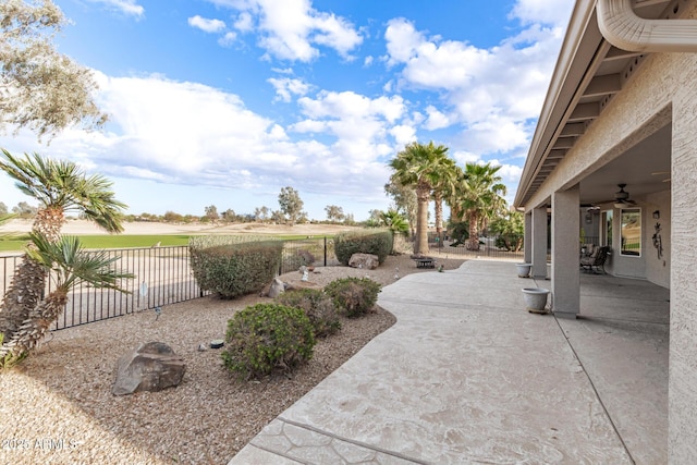 exterior space with a fenced backyard, a ceiling fan, and a patio area