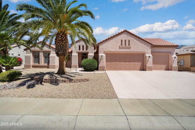 16158 W Copper Point Ln, Surprise, AZ 85374 - mediterranean / spanish-style home featuring stucco siding, an attached garage, concrete driveway, and a tile roof