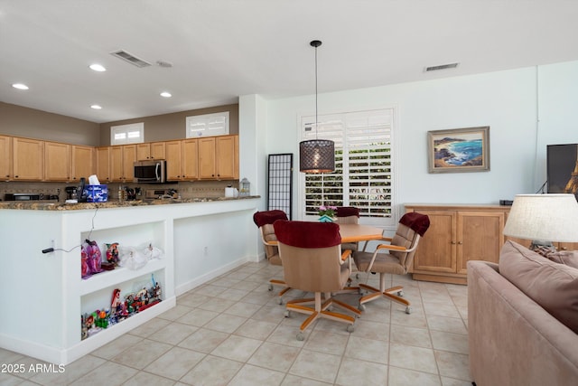16158 W Copper Point Ln, Surprise, AZ 85374 - kitchen featuring stainless steel microwave, healthy amount of natural light, recessed lighting, and light tile patterned floors