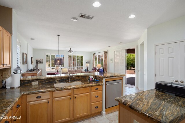 16158 W Copper Point Ln, Surprise, AZ 85374 - kitchen with a sink, stainless steel dishwasher, open floor plan, light tile patterned flooring, and a peninsula