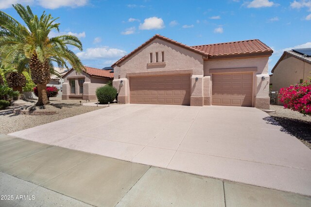 16158 W Copper Point Ln, Surprise, AZ 85374 - mediterranean / spanish home featuring stucco siding, a tile roof, an attached garage, and driveway