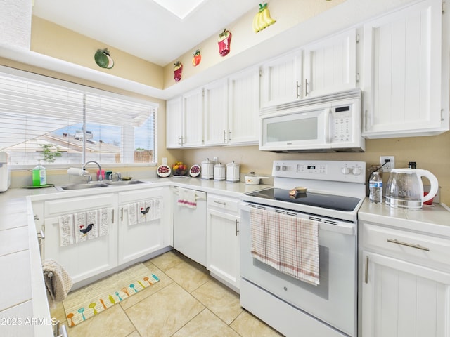 7676 W Sells Dr, Phoenix, AZ 85033 - kitchen featuring white appliances, white cabinetry, light tile patterned flooring, light countertops, and a sink