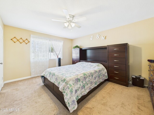 7676 W Sells Dr, Phoenix, AZ 85033 - bedroom with light colored carpet, baseboards, and ceiling fan