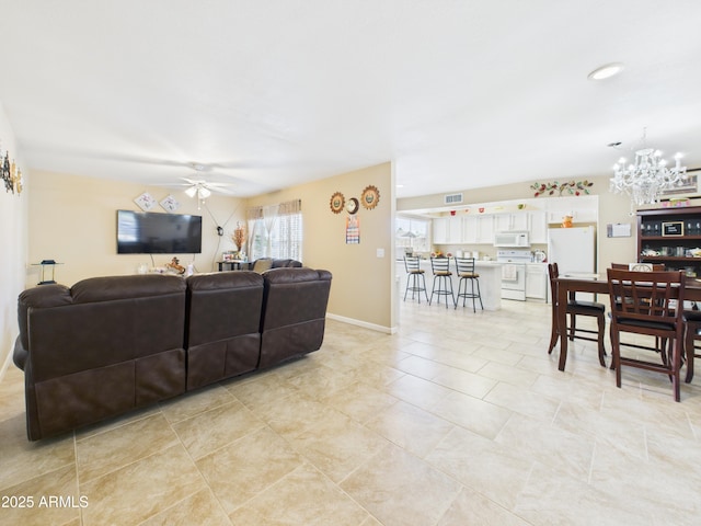 7676 W Sells Dr, Phoenix, AZ 85033 - living room with ceiling fan with notable chandelier, light tile patterned flooring, baseboards, and visible vents