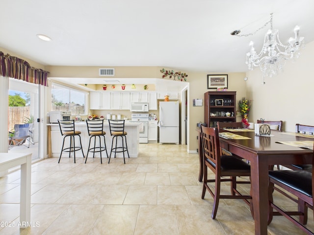 7676 W Sells Dr, Phoenix, AZ 85033 - dining space featuring recessed lighting, a notable chandelier, light tile patterned floors, and visible vents